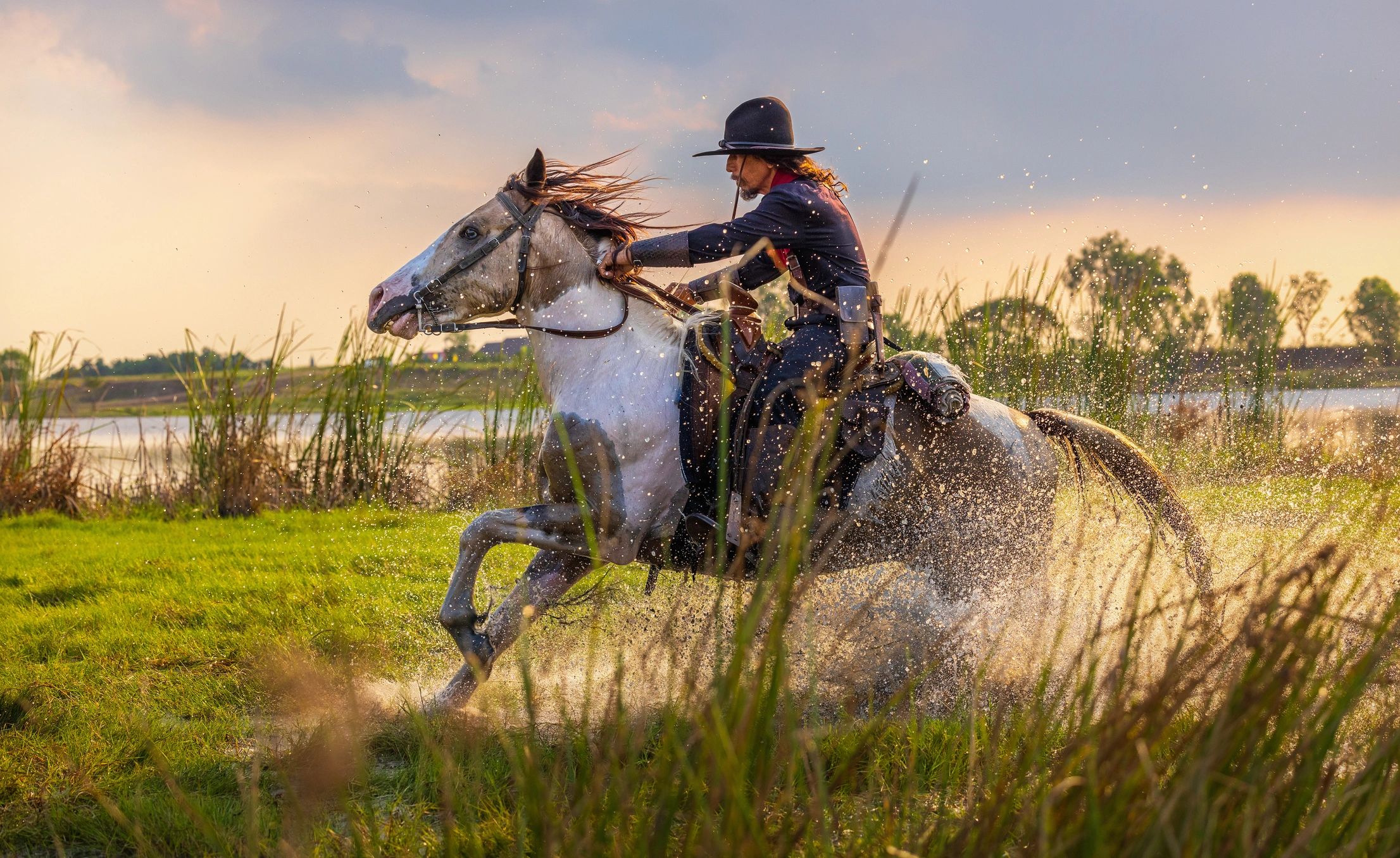 Western riders on horses outdoors at golden hour
