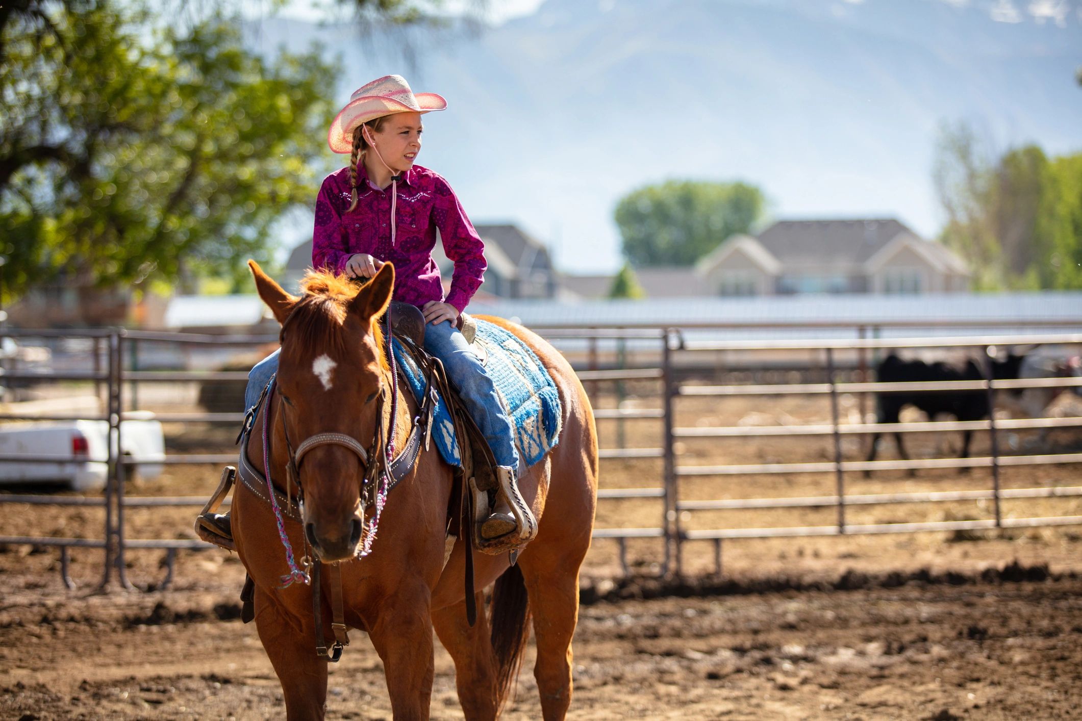 Young rider on a horse in a ranch setting